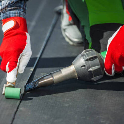 Contractor Covering Building Roof with EPDM Vinyl Rubber Material