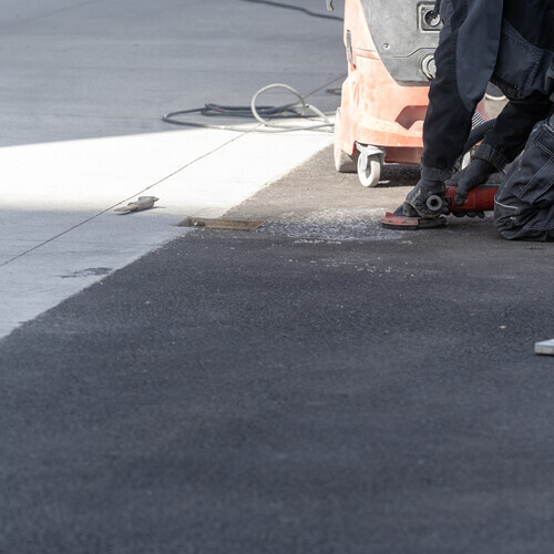 workers performing repairs on a commercial roof