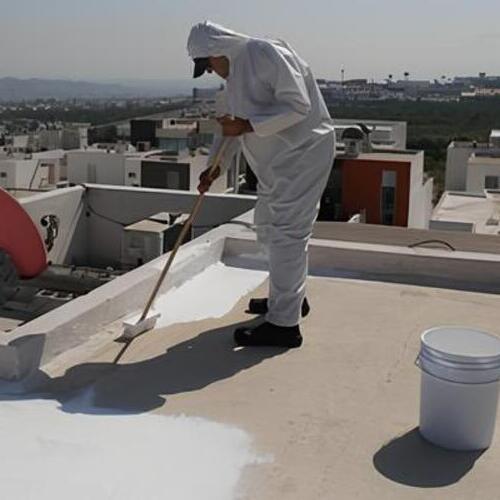 worker applying an elastomeric roof coating