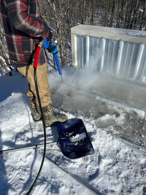 worker removing an ice dam