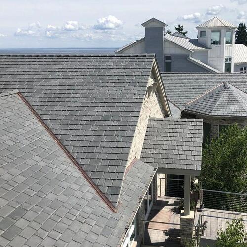 a home with a gray asphalt shingle roof